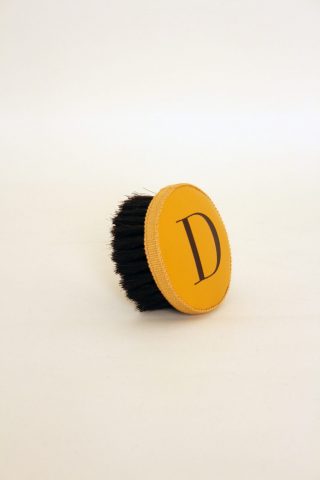 Brush with embossed letter D